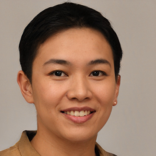 Joyful latino young-adult female with short  black hair and brown eyes