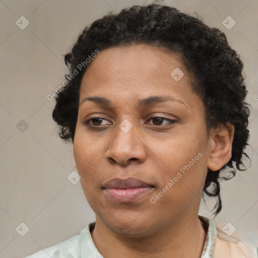 Joyful black adult female with short  brown hair and brown eyes