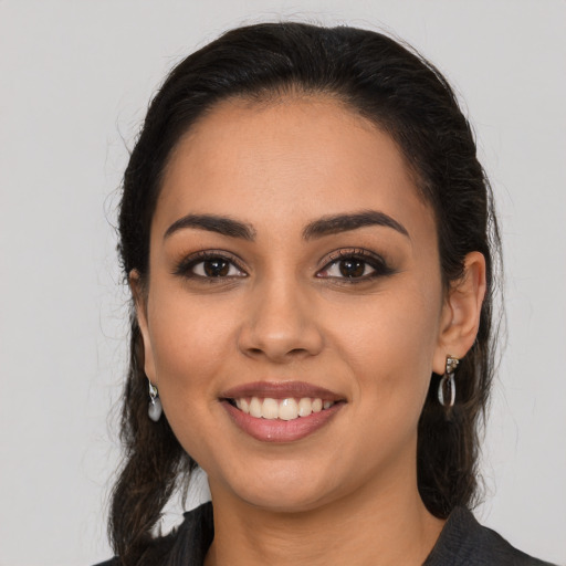 Joyful latino young-adult female with long  brown hair and brown eyes