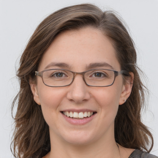 Joyful white adult female with medium  brown hair and grey eyes