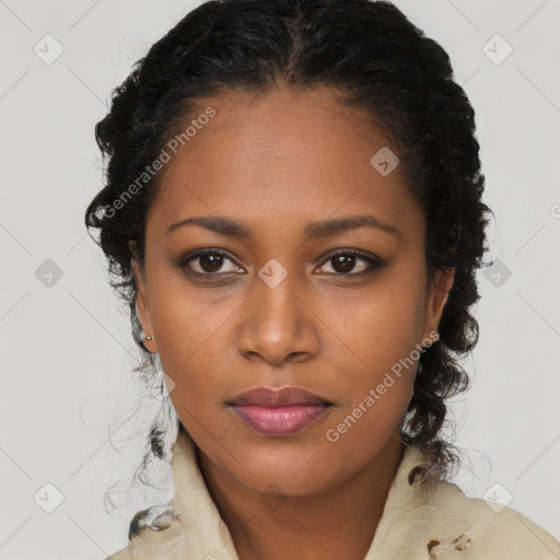 Joyful black young-adult female with long  black hair and brown eyes