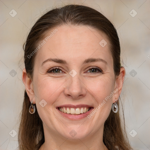 Joyful white adult female with medium  brown hair and grey eyes