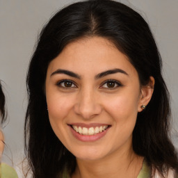 Joyful latino young-adult female with medium  brown hair and brown eyes