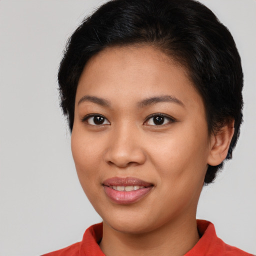 Joyful latino young-adult female with short  brown hair and brown eyes