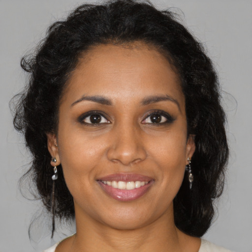 Joyful black young-adult female with medium  brown hair and brown eyes