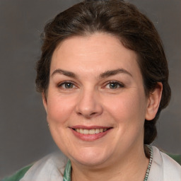 Joyful white adult female with medium  brown hair and brown eyes