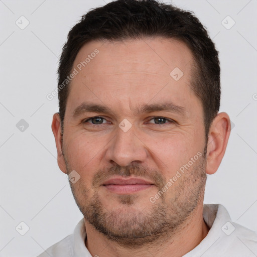 Joyful white adult male with short  brown hair and brown eyes