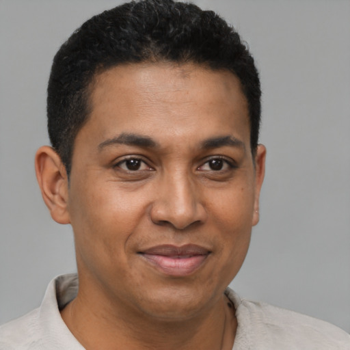 Joyful latino adult male with short  brown hair and brown eyes