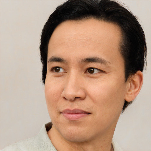 Joyful asian young-adult male with short  brown hair and brown eyes