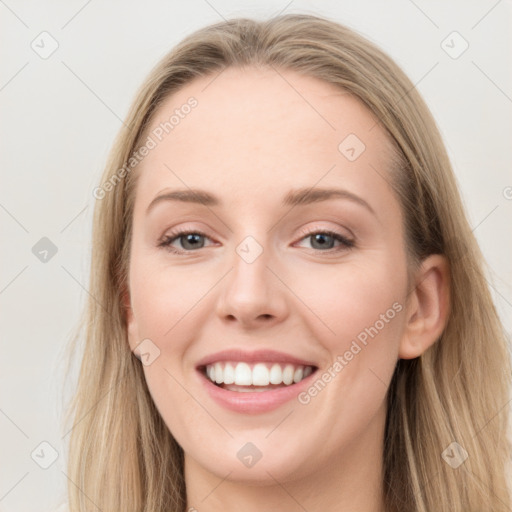 Joyful white young-adult female with long  brown hair and blue eyes