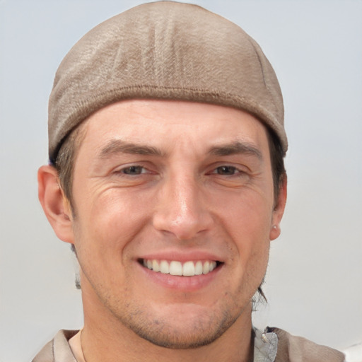 Joyful white adult male with short  brown hair and brown eyes