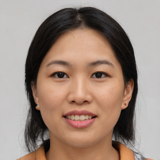 Joyful asian young-adult female with medium  black hair and brown eyes