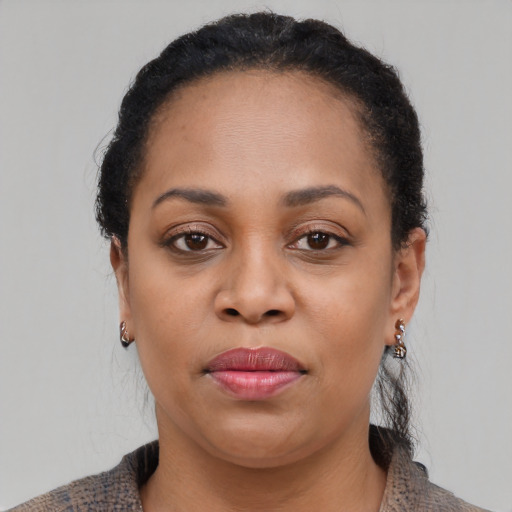 Joyful latino adult female with short  brown hair and brown eyes