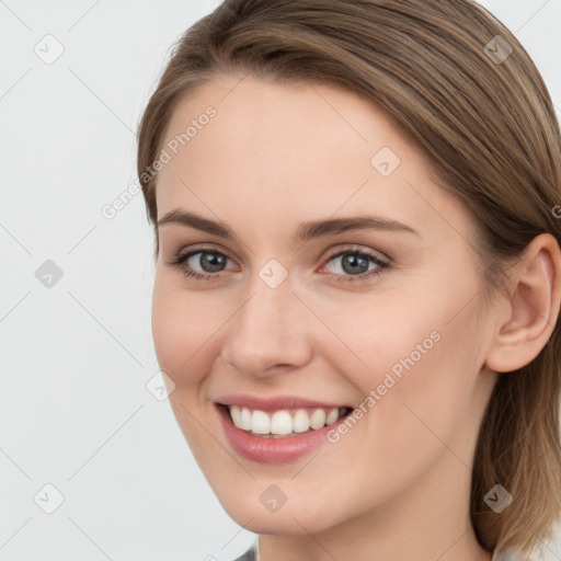 Joyful white young-adult female with long  brown hair and grey eyes