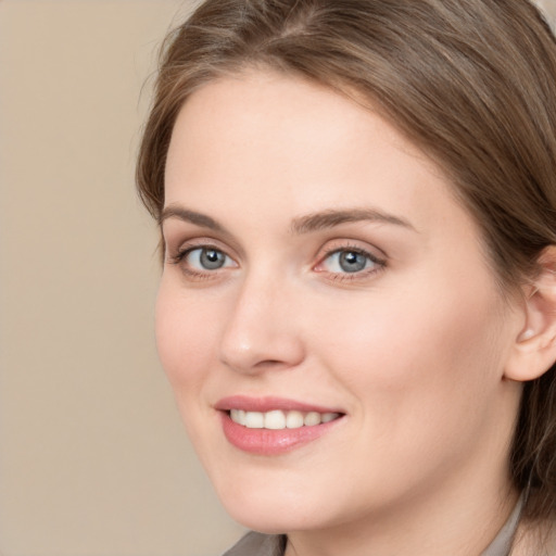 Joyful white young-adult female with long  brown hair and grey eyes