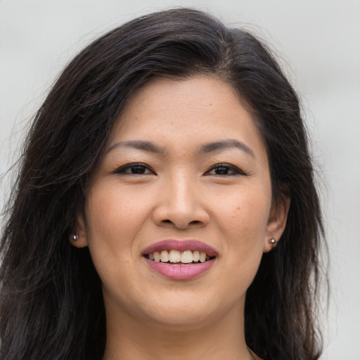 Joyful asian young-adult female with long  brown hair and brown eyes