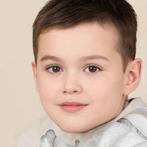 Joyful white child male with short  brown hair and brown eyes