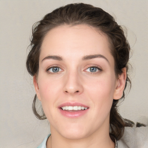 Joyful white young-adult female with medium  brown hair and blue eyes