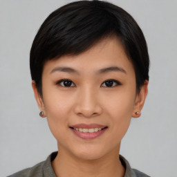 Joyful asian young-adult female with short  black hair and brown eyes