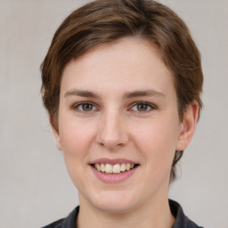 Joyful white young-adult female with medium  brown hair and grey eyes