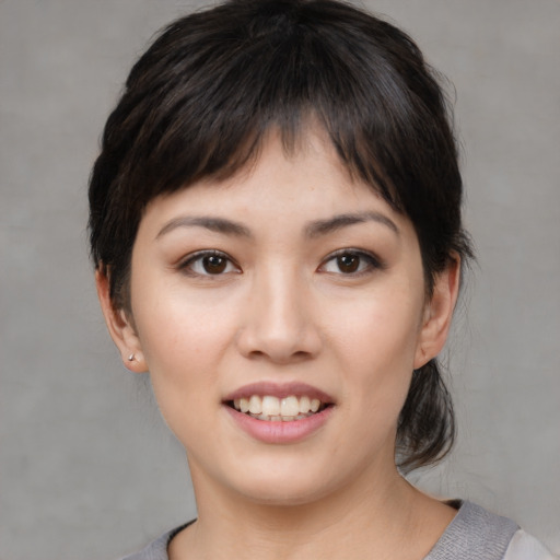 Joyful white young-adult female with medium  black hair and brown eyes