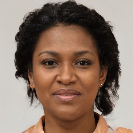 Joyful black young-adult female with medium  brown hair and brown eyes