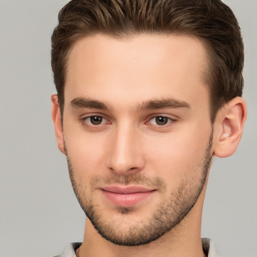 Joyful white young-adult male with short  brown hair and brown eyes