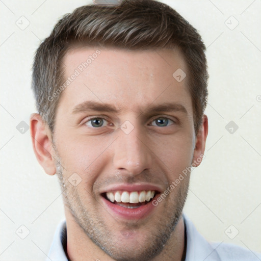 Joyful white young-adult male with short  brown hair and grey eyes