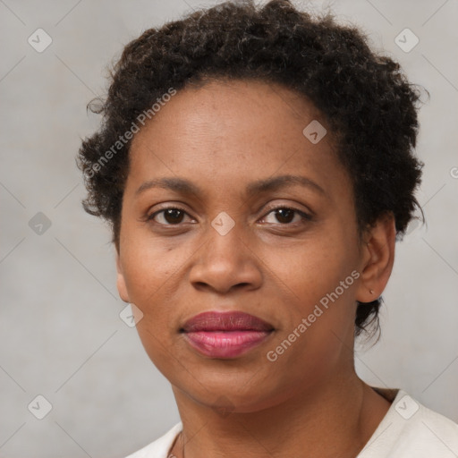 Joyful black adult female with short  brown hair and brown eyes