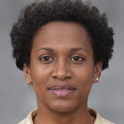Joyful black adult female with short  brown hair and brown eyes