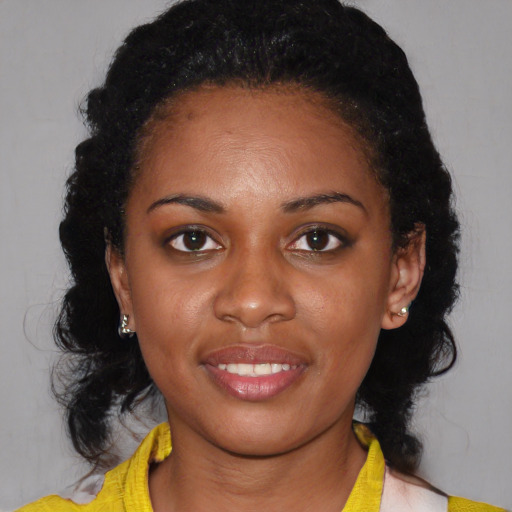 Joyful black young-adult female with medium  black hair and brown eyes
