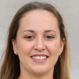 Joyful white young-adult female with long  brown hair and grey eyes