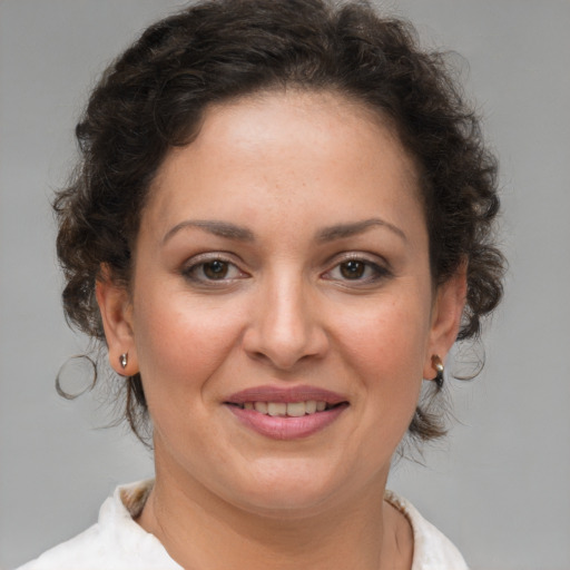 Joyful white adult female with short  brown hair and brown eyes