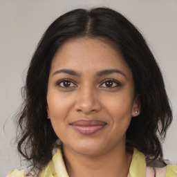 Joyful black young-adult female with medium  brown hair and brown eyes