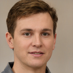 Joyful white adult male with short  brown hair and grey eyes