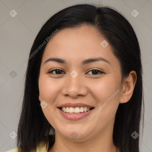 Joyful asian young-adult female with long  brown hair and brown eyes