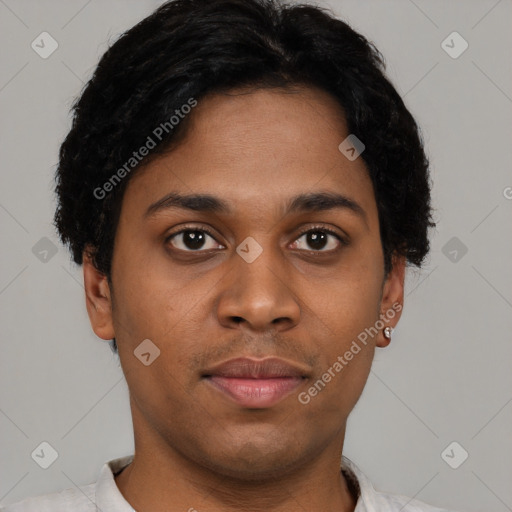 Joyful black young-adult male with short  black hair and brown eyes