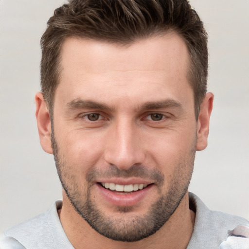 Joyful white young-adult male with short  brown hair and brown eyes