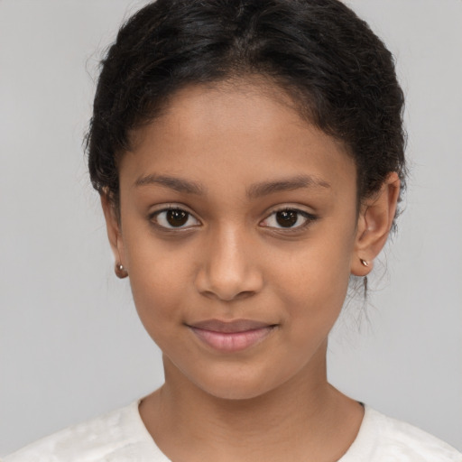 Joyful latino child female with short  brown hair and brown eyes