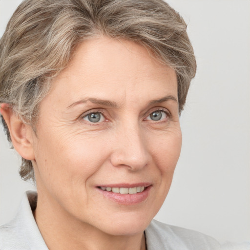 Joyful white adult female with short  brown hair and grey eyes