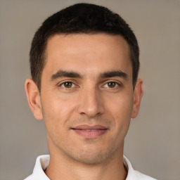 Joyful white young-adult male with short  brown hair and brown eyes