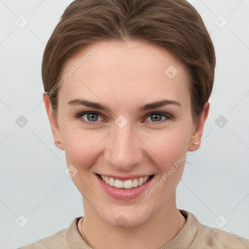 Joyful white young-adult female with short  brown hair and grey eyes