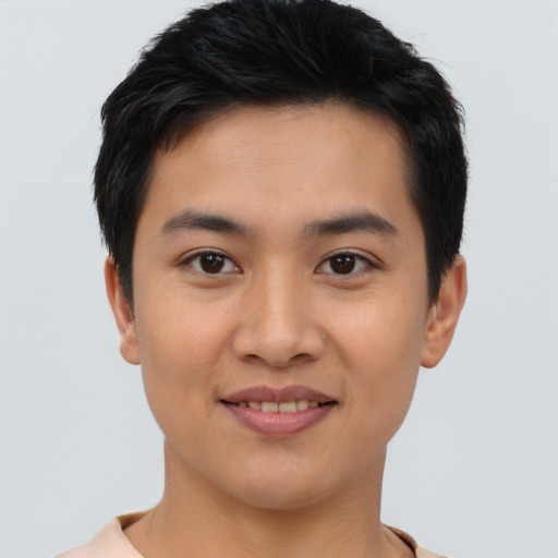 Joyful asian young-adult male with short  brown hair and brown eyes