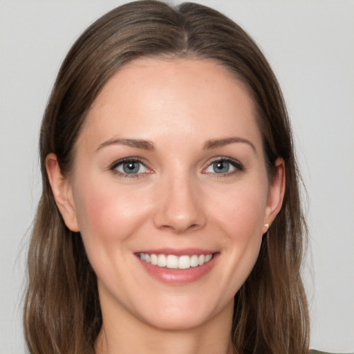 Joyful white young-adult female with long  brown hair and grey eyes