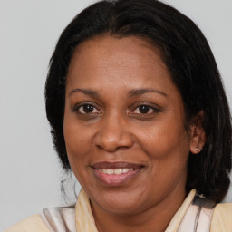 Joyful black adult female with medium  brown hair and brown eyes