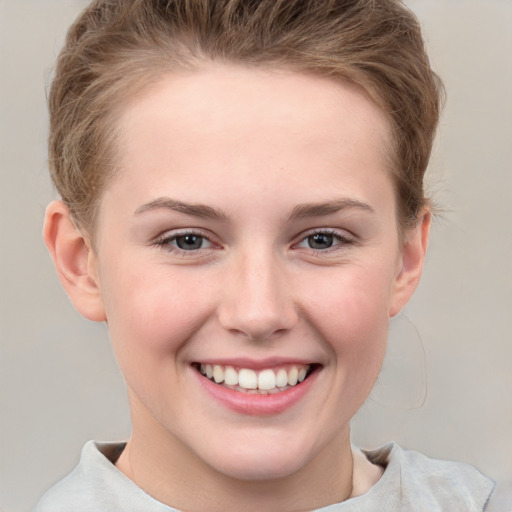 Joyful white child female with short  brown hair and grey eyes