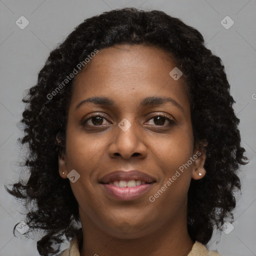 Joyful black young-adult female with long  brown hair and brown eyes