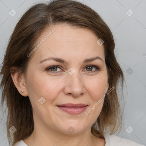 Joyful white adult female with medium  brown hair and brown eyes