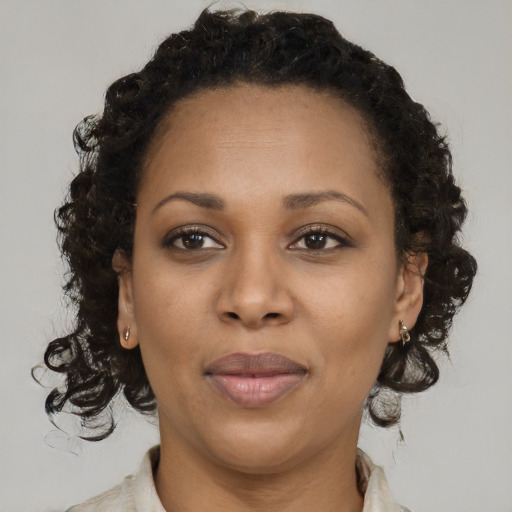 Joyful black adult female with short  brown hair and brown eyes