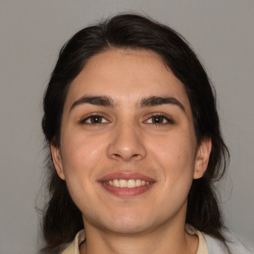 Joyful white young-adult female with medium  brown hair and brown eyes